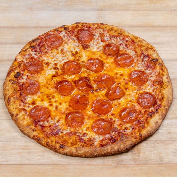 A whole pepperoni pizza with melted cheese and a golden crust, centered on a light wooden surface.
